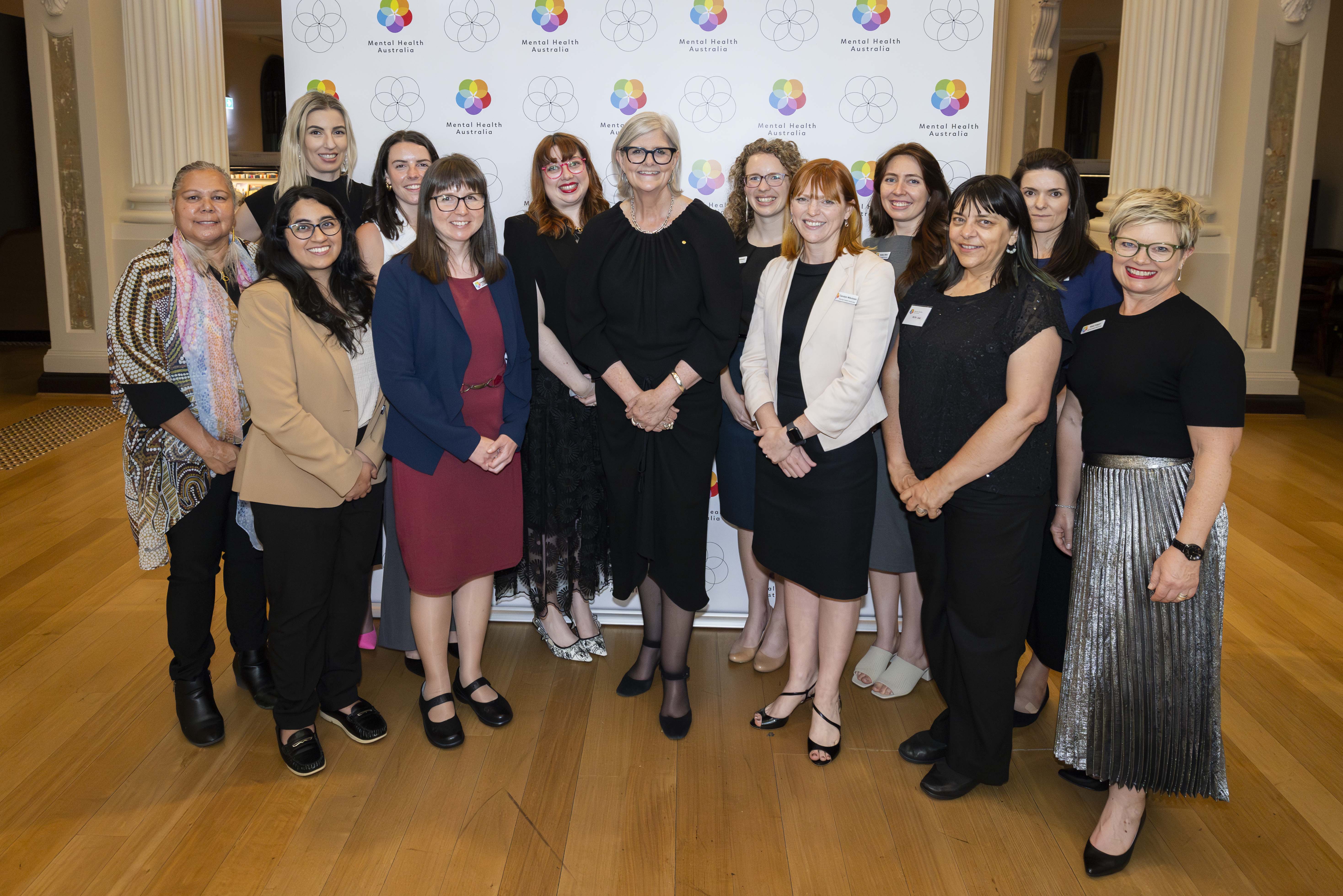 Group of people with the Governor-General smiling at the camera